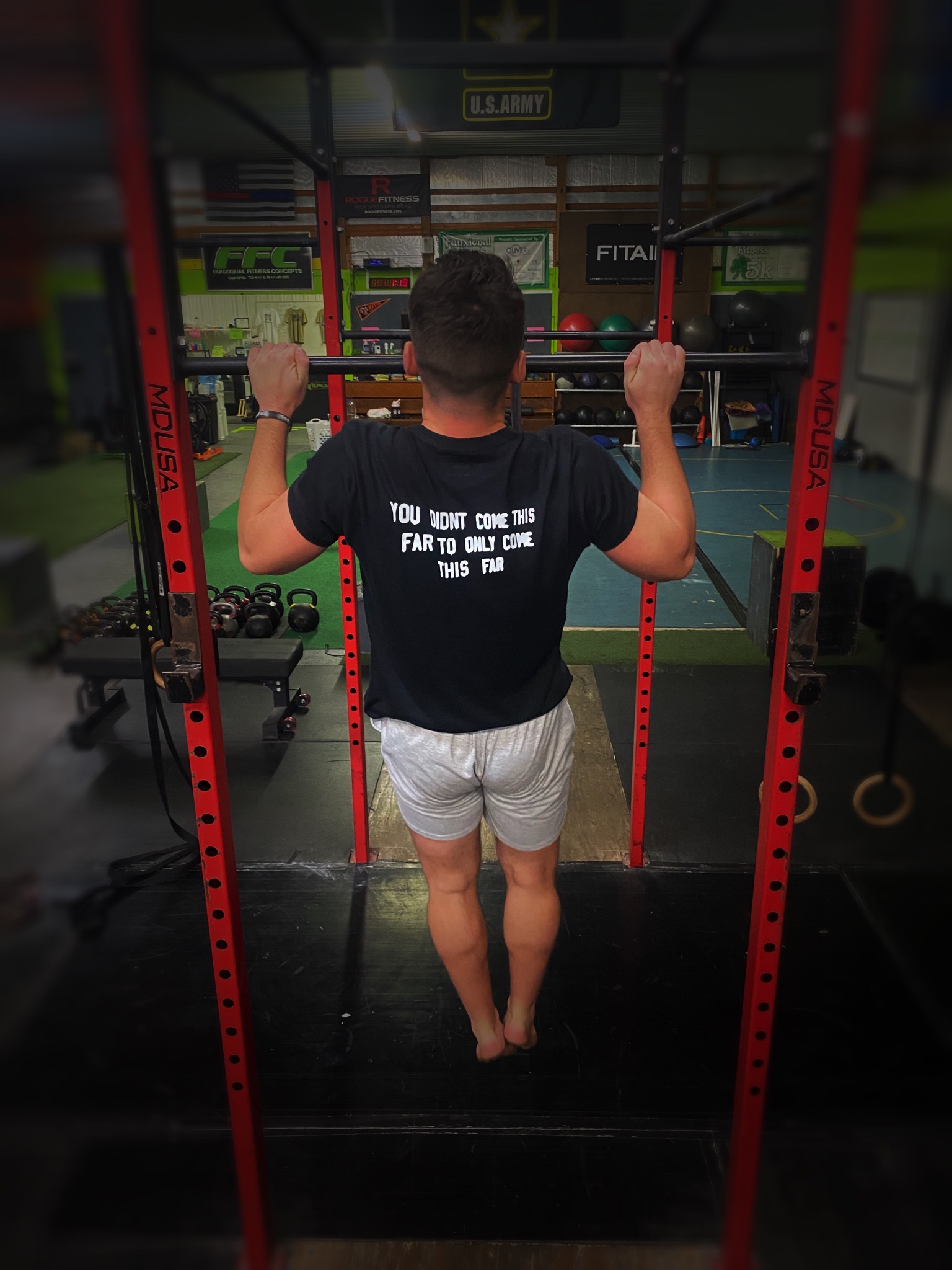 Ethan Bible doing pull ups in a shirt that reads You didn't come this far to only come this far